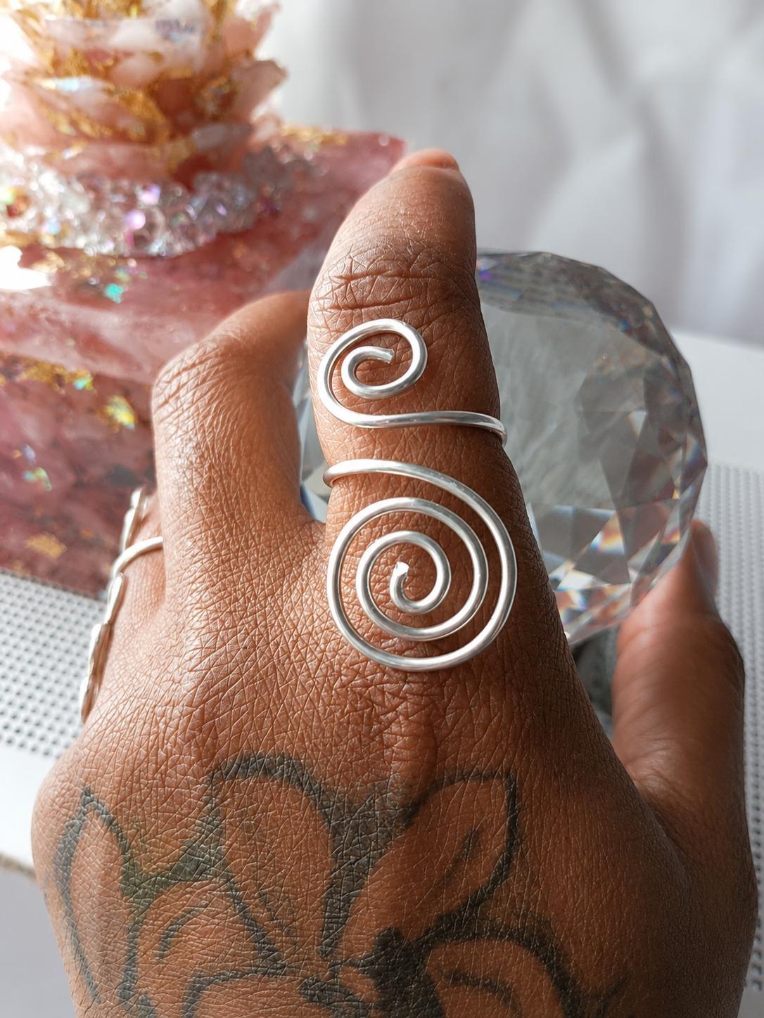 The House Spiral ring, a single strand of sterling silver formed into two opposing spirals.