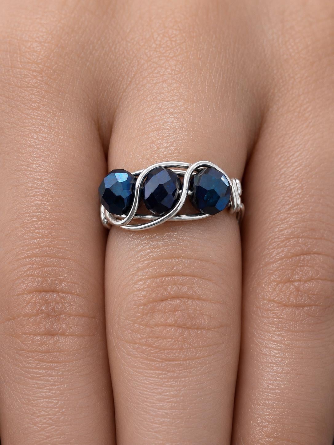 Midnight Trinity, three sapphire-blue crystals woven into flowing sterling silver.