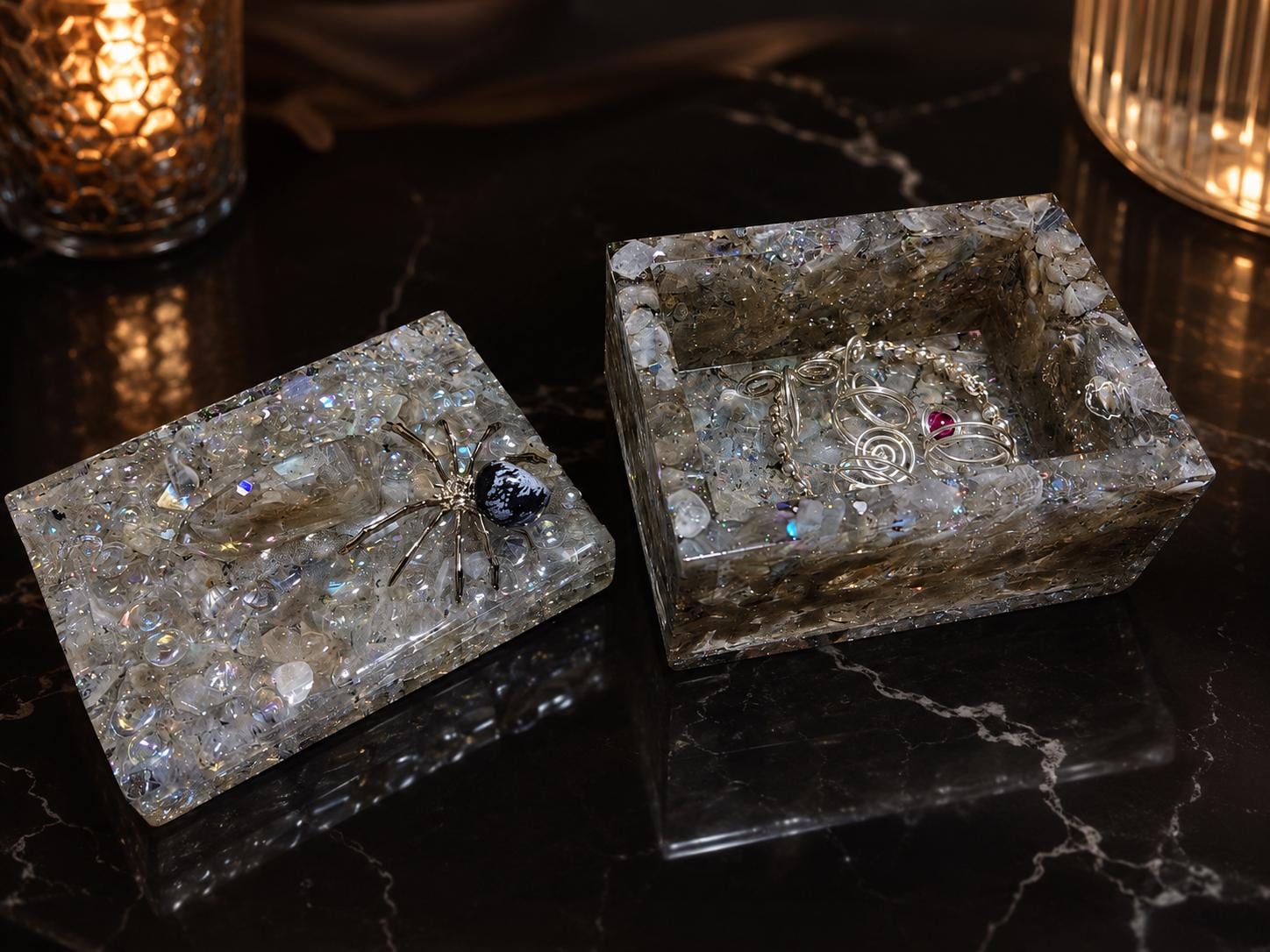 The Grey Moonstone Spider box, a sculpted spider resting above a faceted crystal on a pale moonstone lid.