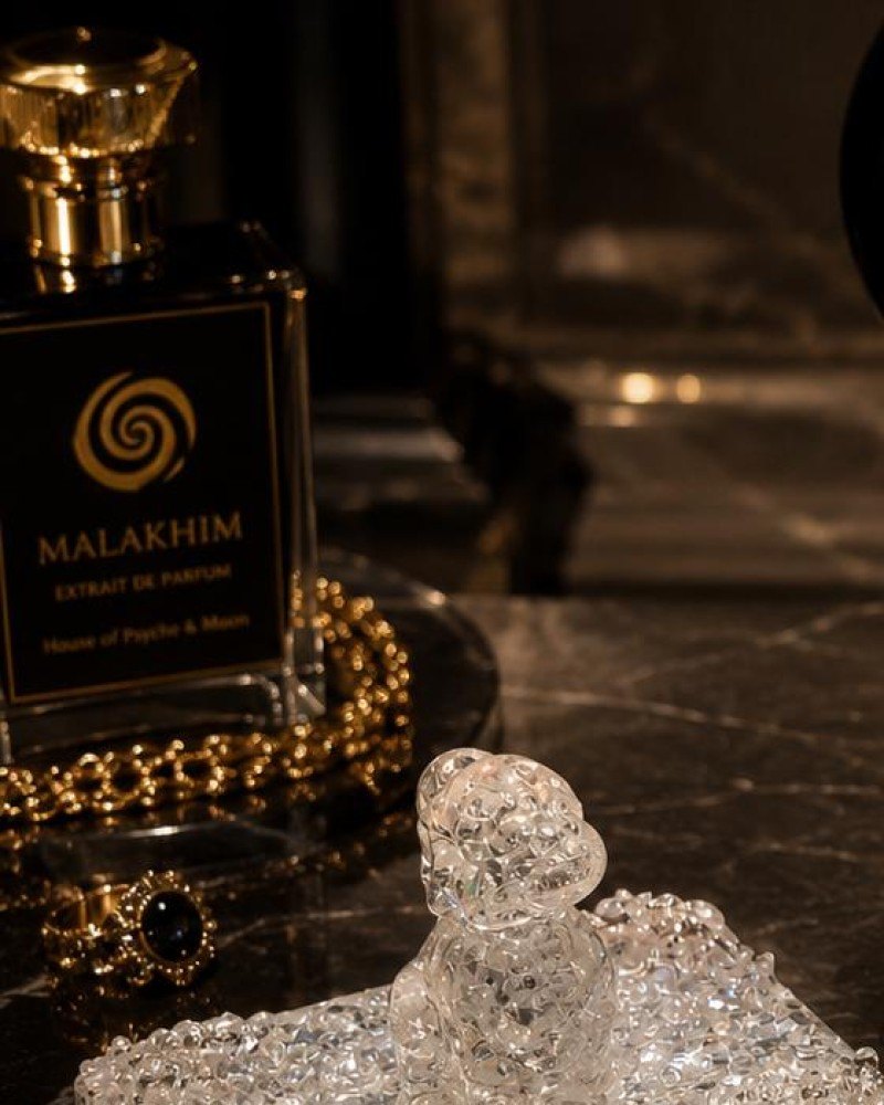 A bottle of Malakhim extrait de parfum by House of Psyche & Moon on dark marble.